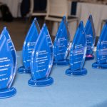 Awards are displayed on a table.