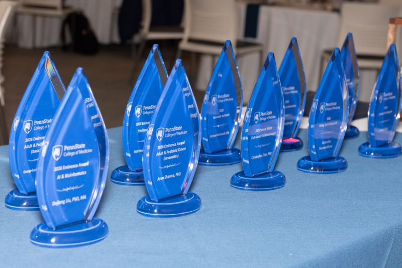 Awards are displayed on a table.