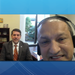 In a split-screen image, Hector Ortiz, program manager for education with Penn State Health’s Office of Health Advancement and Community Engagement, is shown on the right with a set of earphones conducting the podcast. On the left side of the screen is Don McKenna, president of Milton S. Hershey Medical Center. Dressed in a business suit, McKenna sits in a chair in his office. A bookcase is behind him.