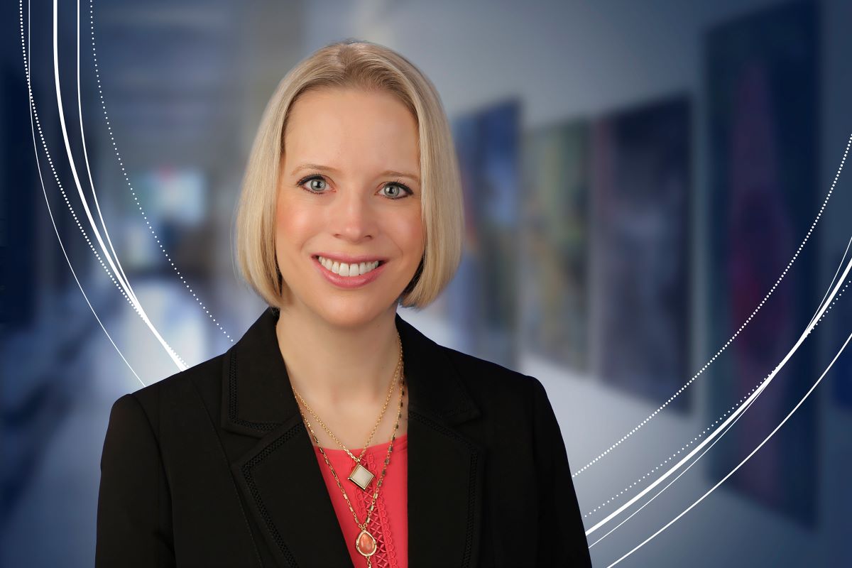 Jennifer Kraschnewski, MD, MPH, poses for a professional portrait in front of a blurred indoor background.
