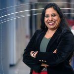 Indira Mysorekar, PhD, poses for a professional portrait with arms crossed in an indoor setting.