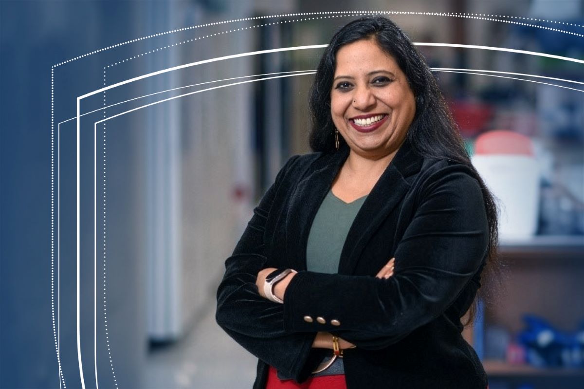 Indira Mysorekar, PhD, poses for a professional portrait with arms crossed in an indoor setting.
