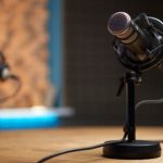 A podcast microphone on a desk in a recording studio