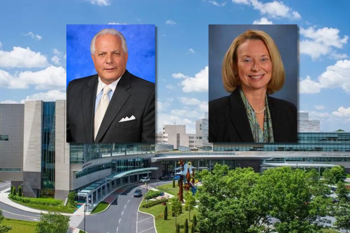 Composite image showing two professional headshots positioned above the entrance of a large modern hospital building. The headshot on the left features a man in a dark suit and light tie against a blue background. The headshot on the right features a woman in a dark blazer and patterned scarf against a gray-blue background. The hospital campus is visible below, with glass-fronted architecture, a circular drive, trees, and a partly cloudy sky.