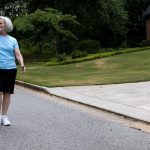 Older woman walking on a sidewalk