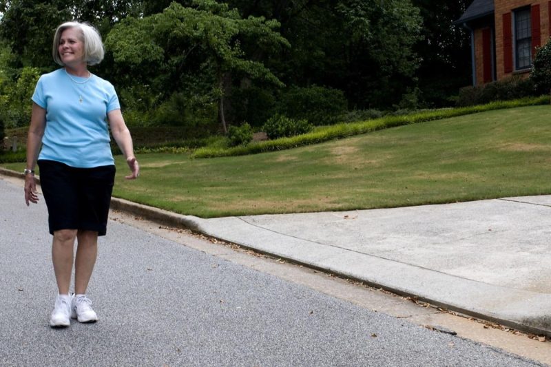 Older woman walking on a sidewalk