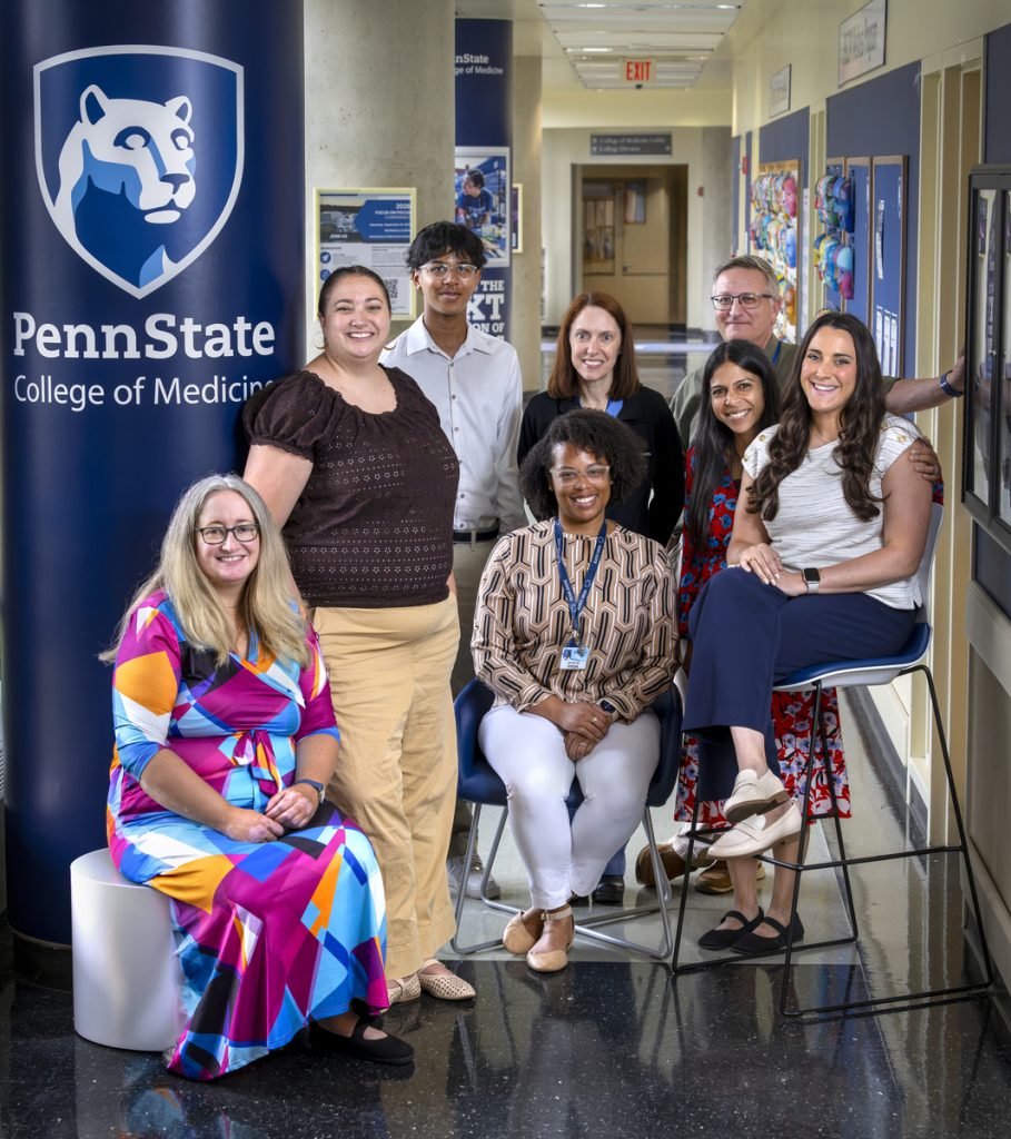 Eight people involved in the street medicine program in the hallway of the College of Medicine