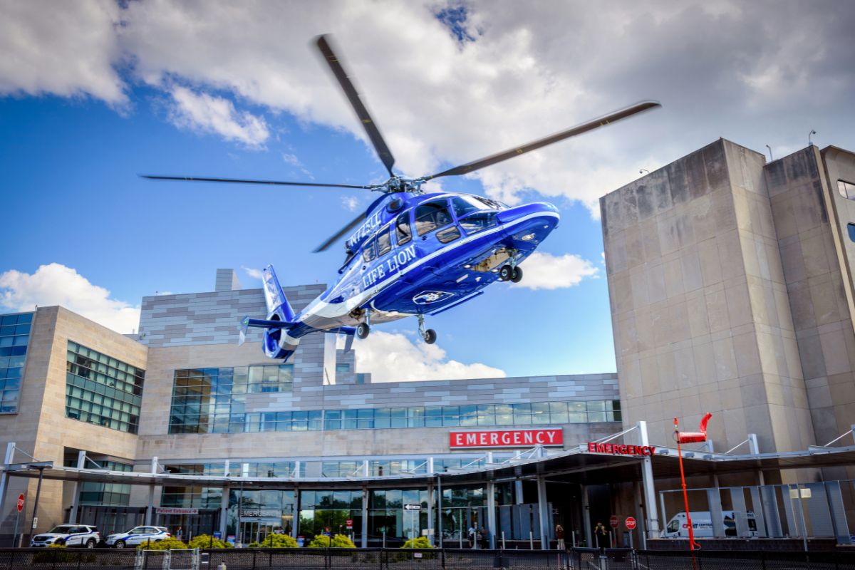 Life Lion medical helicopter approaching the helipad above the emergency department entrance at Penn State Health Milton S. Hershey Medical Center.
